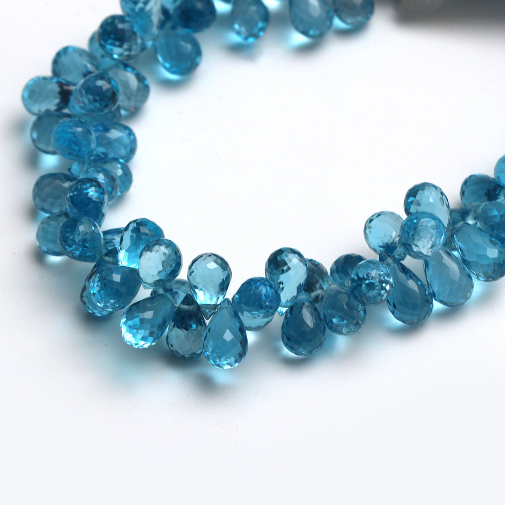 Swise Blue Topaz Drops Faceted Beads, 8x5 mm to 10x5 mm, Blue Topaz Drop Beads, - Gem Quality , 8 Inch/ 46 Cm Full Strand, Price Per Strand - National Facets, Gemstone Manufacturer, Natural Gemstones, Gemstone Beads