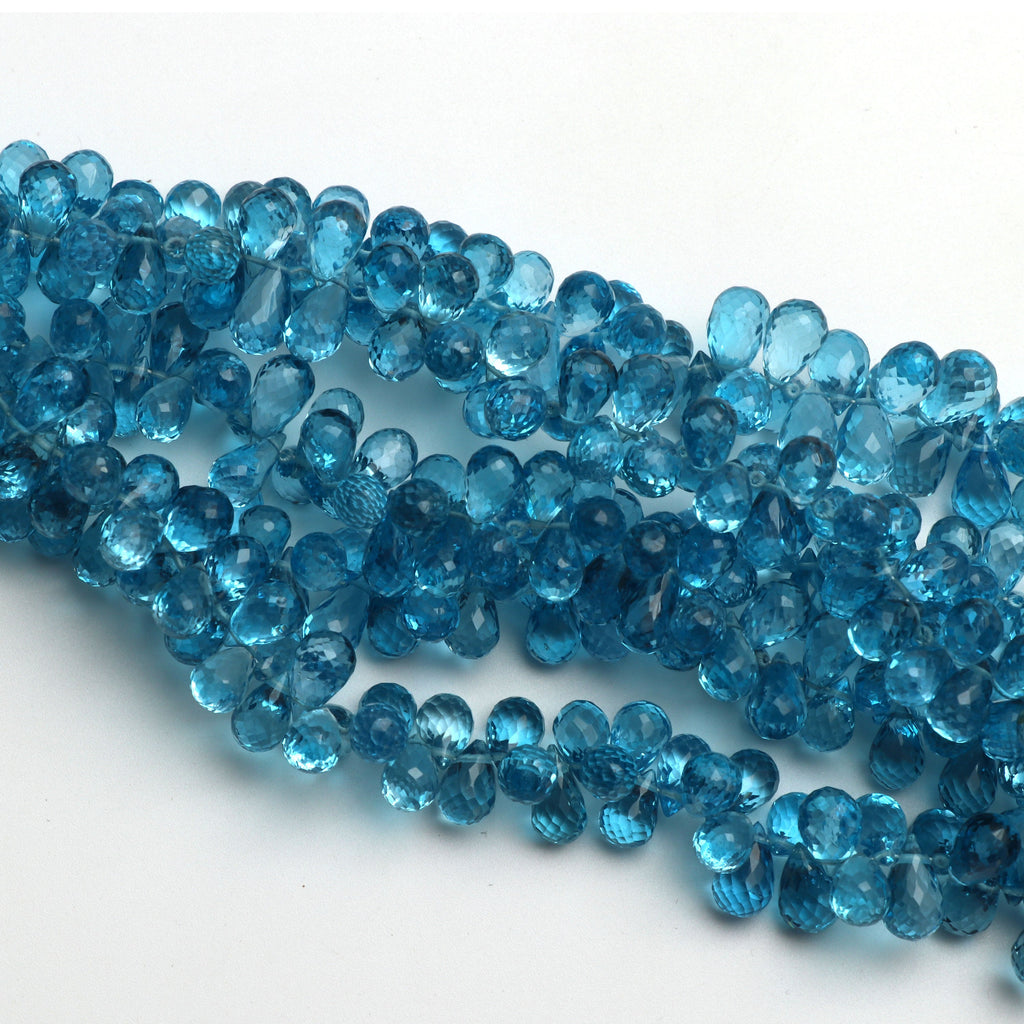 Swise Blue Topaz Drops Faceted Beads, 8x5 mm to 10x5 mm, Blue Topaz Drop Beads, - Gem Quality , 8 Inch/ 46 Cm Full Strand, Price Per Strand - National Facets, Gemstone Manufacturer, Natural Gemstones, Gemstone Beads