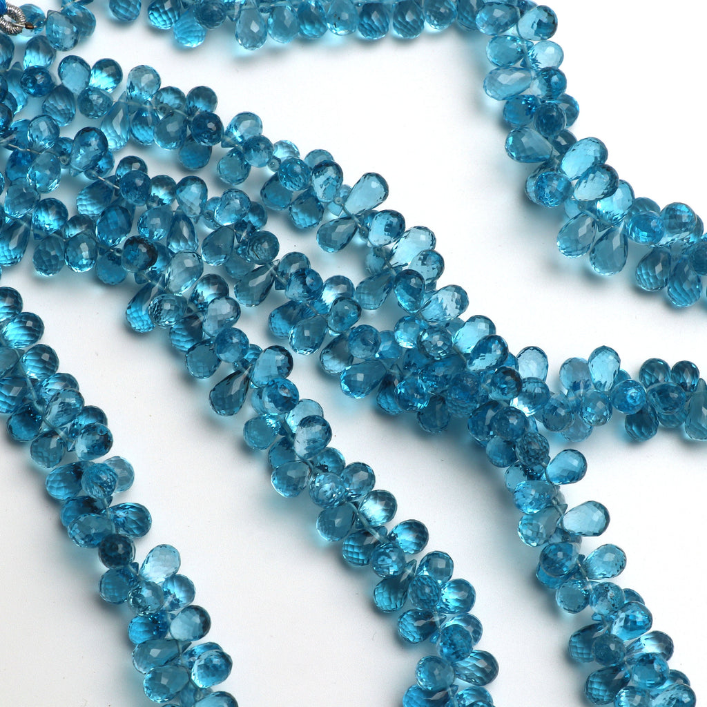 Swise Blue Topaz Drops Faceted Beads, 8x5 mm to 10x5 mm, Blue Topaz Drop Beads, - Gem Quality , 8 Inch/ 46 Cm Full Strand, Price Per Strand - National Facets, Gemstone Manufacturer, Natural Gemstones, Gemstone Beads