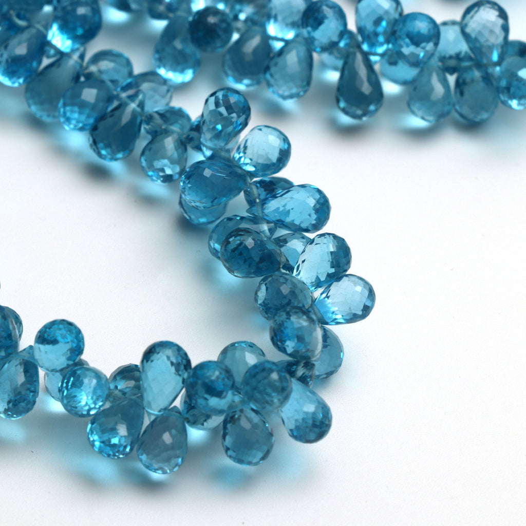 Swise Blue Topaz Drops Faceted Beads, 8x5 mm to 10x5 mm, Blue Topaz Drop Beads, - Gem Quality , 8 Inch/ 46 Cm Full Strand, Price Per Strand - National Facets, Gemstone Manufacturer, Natural Gemstones, Gemstone Beads