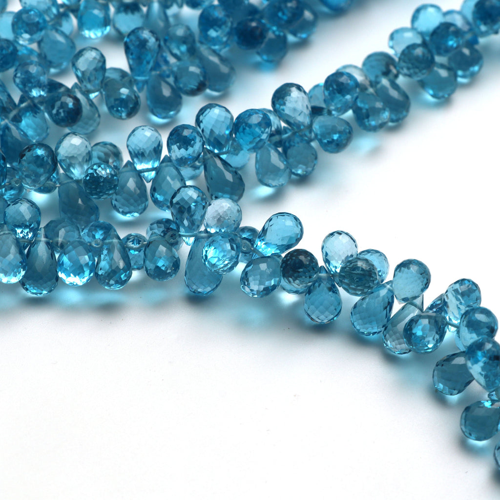 Swise Blue Topaz Drops Faceted Beads, 8x5 mm to 10x5 mm, Blue Topaz Drop Beads, - Gem Quality , 8 Inch/ 46 Cm Full Strand, Price Per Strand - National Facets, Gemstone Manufacturer, Natural Gemstones, Gemstone Beads